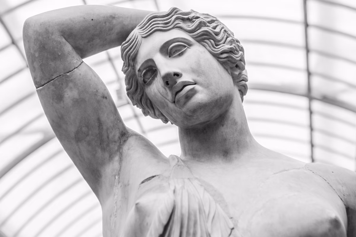 Classical marble statue in black and white, one arm raised