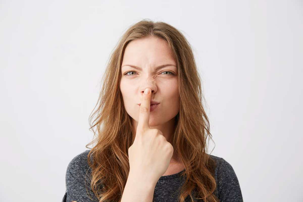 Woman with a finger to her lips, asking for silence